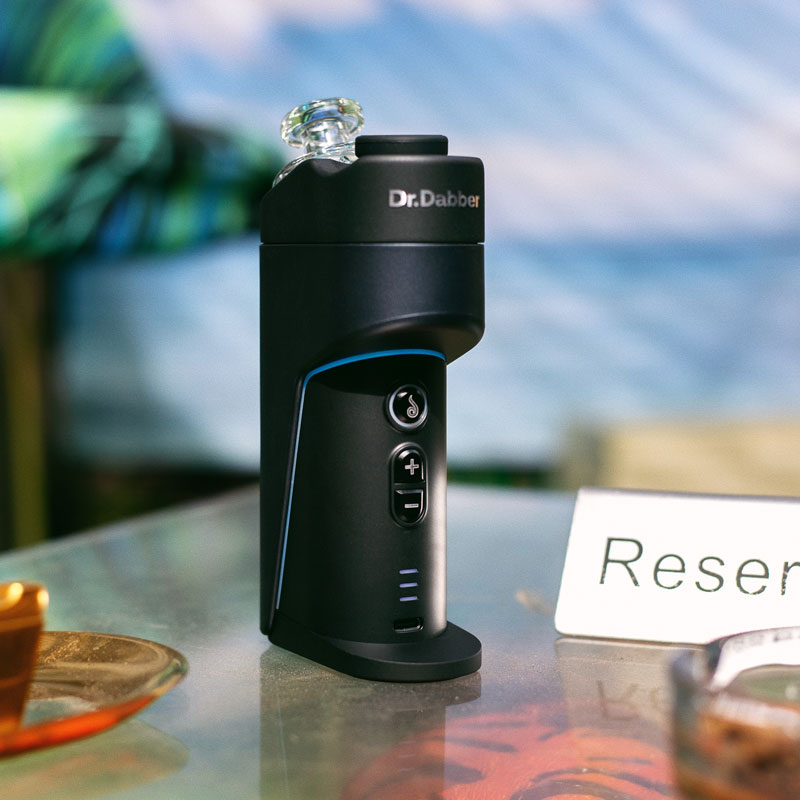Dr. Dabber Switch GO upright on a tabletop with illuminated accent light