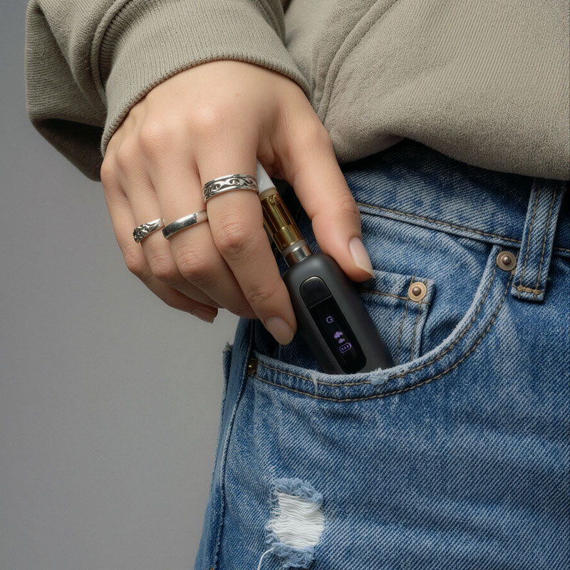 G Pen 510 OG battery being placed inside a jeans pocket