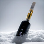 Black G Pen 510 OG battery with cartridge standing upright in snow