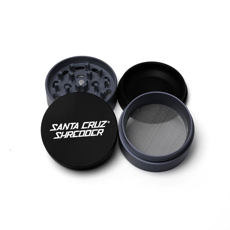 Santa Cruz Shredder Split Series grey and black grinder opened to show the teeth, screen and collection chamber