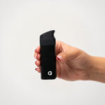 Side view of the G Pen Micro 2 Vaporizer held in hand with black silicone mouthpiece fitted