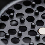 Detailed view of the G Pen Slim Grinder chamber showing grinding pegs and openings