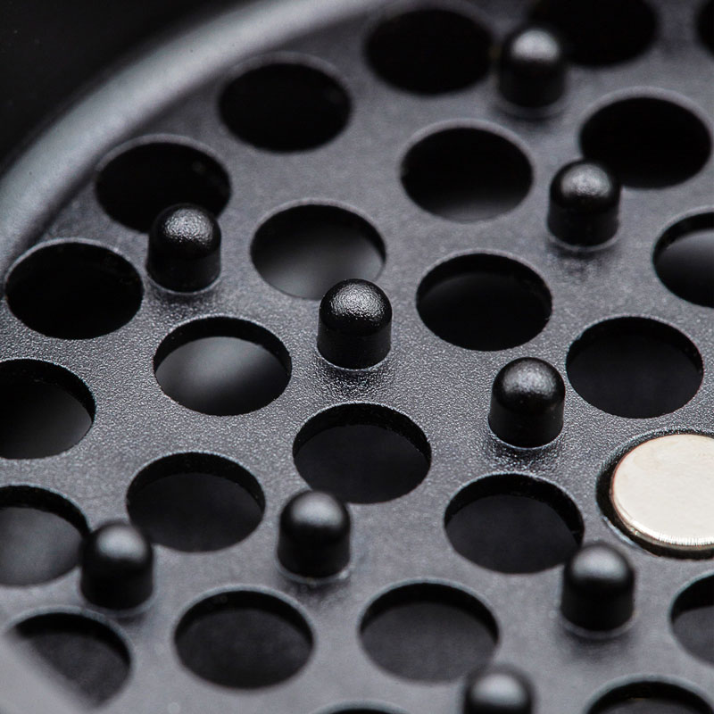 Detailed view of the G Pen Slim Grinder chamber showing grinding pegs and openings