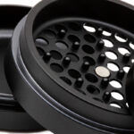 Close up of the G Pen Slim Grinder grinding chamber with pegs, holes and centre magnet
