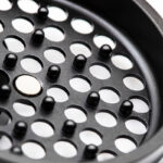 Close up of the G Pen Slim Grinder perforated grinding plate and magnetic centre