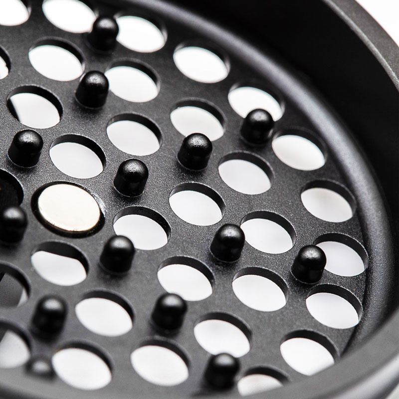 Close up of the G Pen Slim Grinder perforated grinding plate and magnetic centre