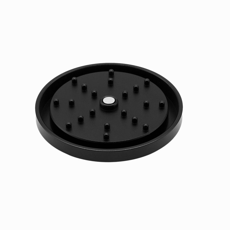 Underside of the G Pen 3-Piece Slim Grinder lid showing grinding pegs and centre magnet