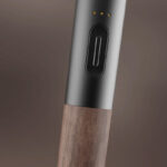 Close up of the Vessel Craftsman 510 Battery showing the power button, three LED indicators and walnut wood finish