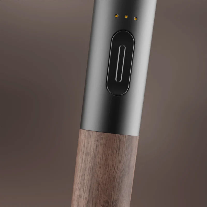 Close up of the Vessel Craftsman 510 Battery showing the power button, three LED indicators and walnut wood finish