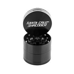 Studio shot of an open, black Santa Cruz Shredder herb grinder.